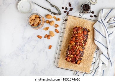 English dried fruitcake. Homemade holiday pie with nuts almonds, fruits raisins and spices. Traditional festive pastries. Christmas. New year. Top view and copy space