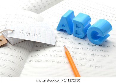 English education, alphabet toy on notebook