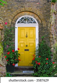English front door. Surrounded by flowers.