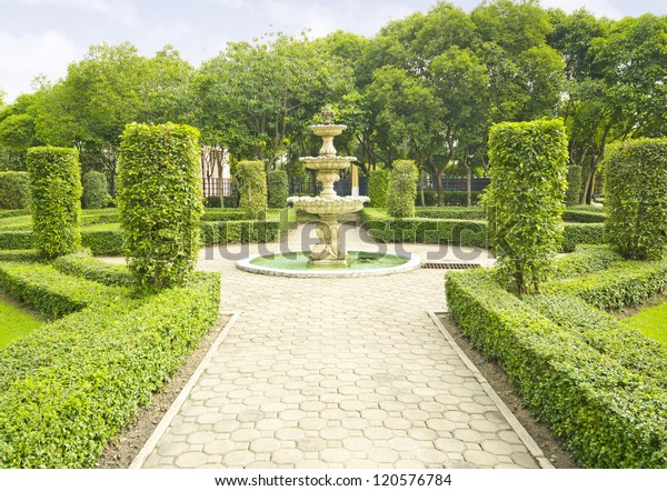 English garden in\
summer, Lush Green\
Topiary