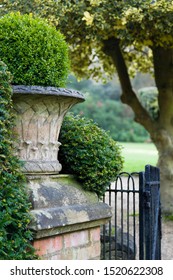 English Garden With A Victorian Stone Urn. England, UK