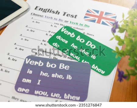English grammar test on wooden table in classroom