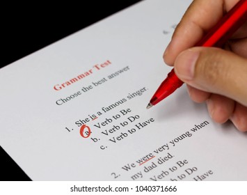 English Grammar Test Sheet On Black Table