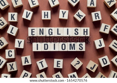 English idioms word concept on cubes