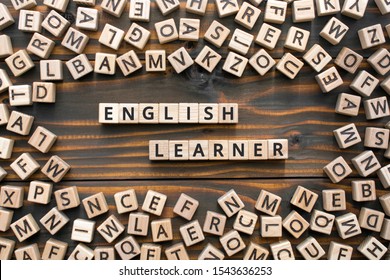 English learner - phrase from wooden blocks with letters, student  english learner concept, random letters around, wooden background