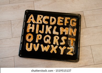 English letters made from sweet pastries on a baking sheet - Powered by Shutterstock