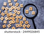 English letters scattered on grey background. Ideas for developing grammatical thinking and learning English, Magnifying glass with letters in English letters