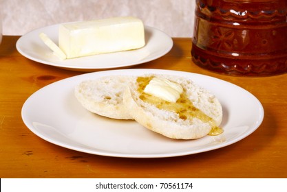 English muffin on vintage wood table with butter and tan background - Powered by Shutterstock