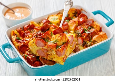 English Muffin Sausage Egg Bake In Baking Dish On White Wooden Table, Landscape View From Above, Close-up