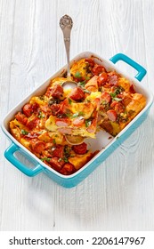 English Muffin Sausage Egg Bake In Baking Dish On White Wooden Table, Vertical View From Above, Close-up