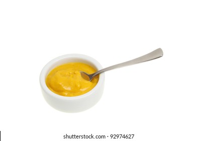 English Mustard In A Ramekin With A Spoon Isolated Against White