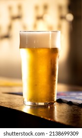 English Pint Of Pale Lager Or Chilled Lager At Pub Counter