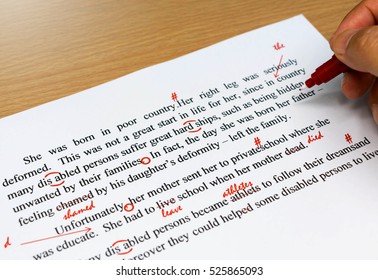 english proofreading sheet with hand holding red pen