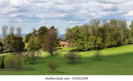 English Rural Landscape With Manor Farm House In The Background