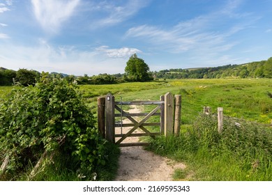 English Rural Scene Of Water Meadows On The South Downs Way Near The Village Of Alfriston With A Wooden Gate In The Foreground