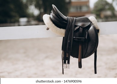 English Saddle Hanging On A Wooden Stable Door