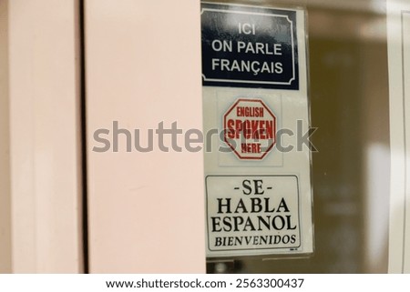 English spoken here Se habla espanol ici on parle francais means sticker signs indicating that in the store we speak English Spanish and French