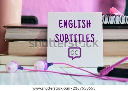 English Subtitles note on desk with related icon. Entertainment concept, selective focus.
