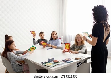English Teacher With Children In The Classroom.