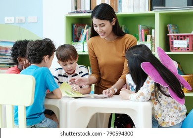 English Teacher Teach Kid In Classroom, Preschool Child, Children And Asian Woman In Class, Group Of Diversity Kindergarten, Education Concept