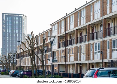 English Terraced Houses In Contrast To Modern Luxury Flats In The Background In East London