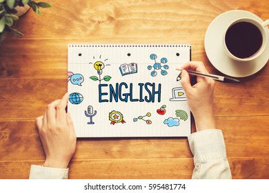 English text with a person holding a pen on a wooden desk - Shutterstock ID 595481774