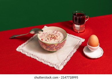 English traditions. Served breakfast table. Food pop art photography. Tea pot, grapefruit and porridge on red tablecloth over green background. Retro 80s, 70s style. Complementary colors, - Shutterstock ID 2147718995