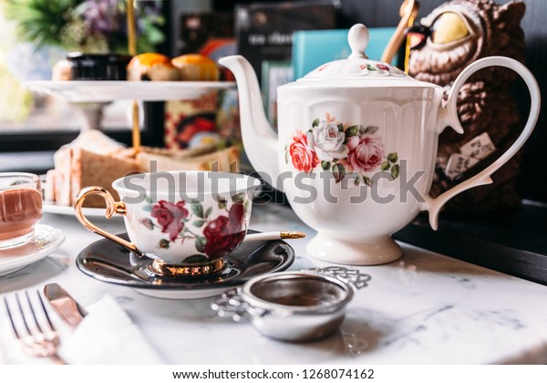 English Vintage Porcelain Roses Tea\
Sets including teapot, tea cup, plate, spoon and tea\
filter.