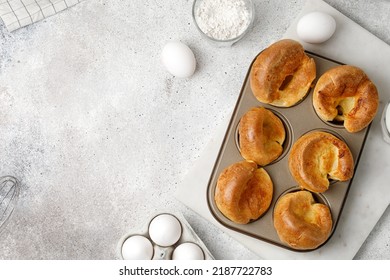 English Yorkshire Pudding In Baking Dish, In Muffin Cups. Homemade Traditional Food. Grey Background. Top View, Copy Space