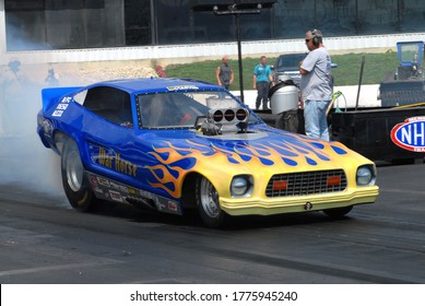 Englishtown, NJ / USA - July 27, 2014: The War Horse Mustang Funny Car Performs A Burnout During A Vintage Drag Racing Event In Englishtown, New Jersey.