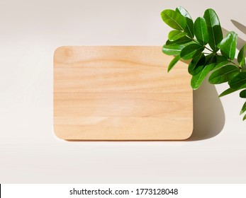 Engraved Wood Text Effect Mockup On Wooden With Green Leaf Background