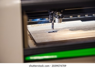 Engraving machine laser cutting into wood - Shutterstock ID 2039074709