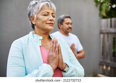 Enhance your mind with meditation. Shot of an older couple meditating together outdoors. - Powered by Shutterstock