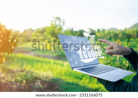 Enhancing Crop Productivity Farmer Analyzing and Optimizing Smart Farming Techniques on Laptop