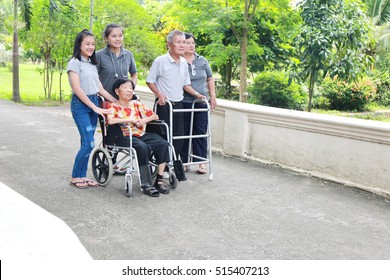 Enjoy Asian Family Member Multi Generation With Grandparent On Green Grass Yard. Big Family Relationship And Happiness Life Concept. 