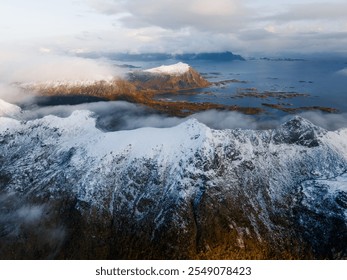 Enjoy a breathtaking aerial view of snowcapped mountains and a serene, picturesque coastline - Powered by Shutterstock