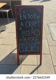 Enjoy a craft beer before Bluesfest street signage at a restaurant entrance way on Rideau Street.