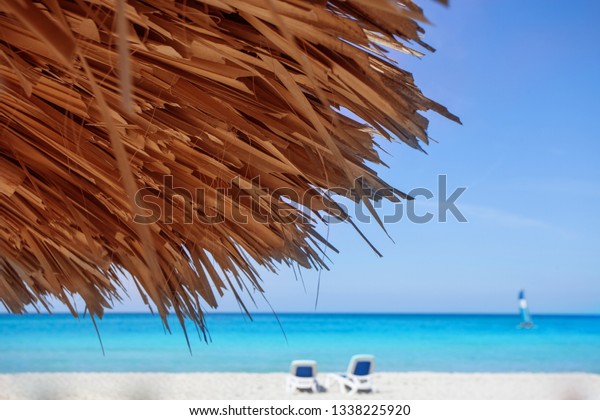 Enjoy the journey through the picturesque\
country of Cuba. Sunbathe on the white beach on the shores of the\
Caribbean Sea. Atlantic Ocean. Chic rest. Blue sky, clear water.\
Sun beds and umbrellas.