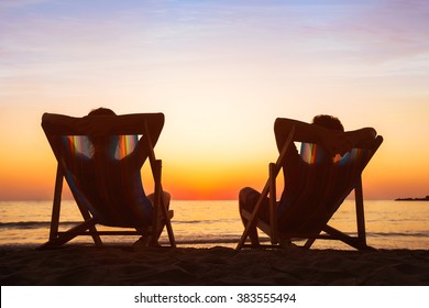 Enjoy Life Concept, Couple Relaxing In Beach Hotel At Sunset, Happy People On Honeymoon, Paradise Travel Destination