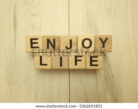 Enjoy life text from wooden blocks. Lifestyle, inspiration concept
