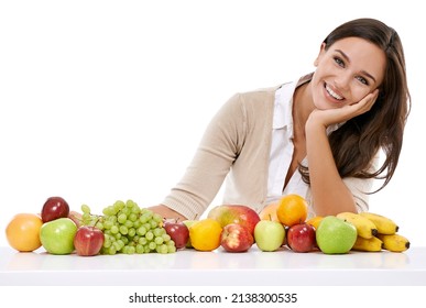 Enjoy Natures Bounty. A Smiling Young Woman Sitting Beside A Selection Of Fruits.