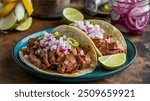 Enjoy the rich flavors of Mexican tacos filled with Cochinita Pibil, a traditional Mayan dish from Yucatan, Mexico, bursting with vibrant and savory taste.
