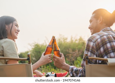 Enjoy Young Asian Woman, Girl And Man Cheering With Beer Bottle, Sitting On Chair . Adventure Couple, People Camping In Forest. Eco Activity, Lifestyle Nature On Holiday Concept.