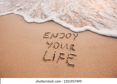 Enjoy Your Life, Happiness Concept, Positive Thinking, Inspirational Quote Written On Sand Beach.