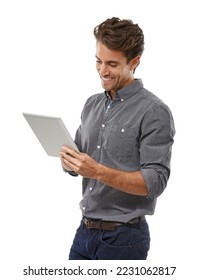 Enjoying the benefits of tablet technology. A handsome young man working on his digital tablet. - Shutterstock ID 2231062817