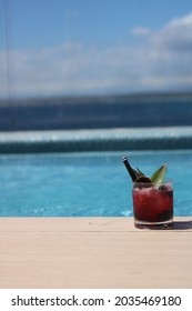 Enjoying A Cocktail Of Fruits Of The Forest Next To An Infinity Pool With Views Of The Sea