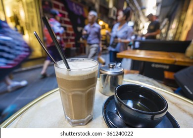 Enjoying coffee and tea at a cafe in a laneway, shallow depth of view