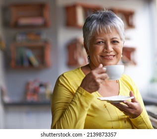 Enjoying A Cup Of Coffee In The Morning. Portrait Of A Mature Woman Enjoying A Warm Beverage At A Coffee Shop.