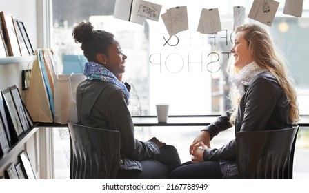 Enjoying A Cup Of Coffee Together. Two Young Women Buying Coffee Together.