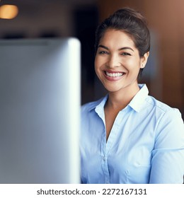 Enjoying every minute of my job. Portrait of a young businesswoman sitting at her office computer. - Shutterstock ID 2272167131